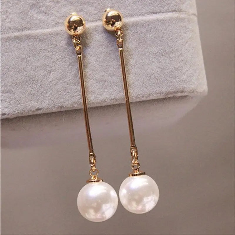 Luxurious dangling earrings with special hand-placed pearls