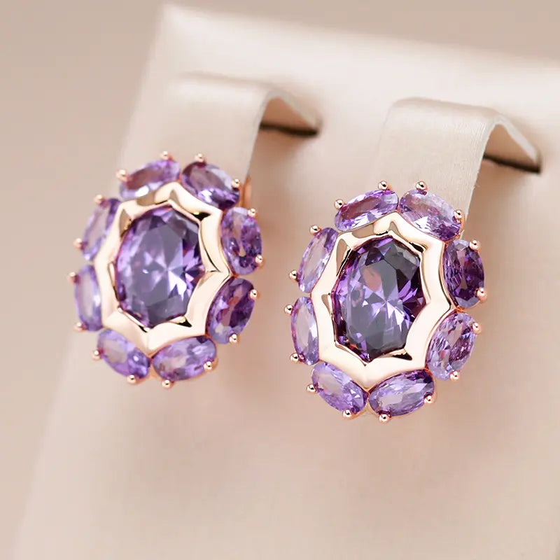 Small gold earrings with purple crystal flowers