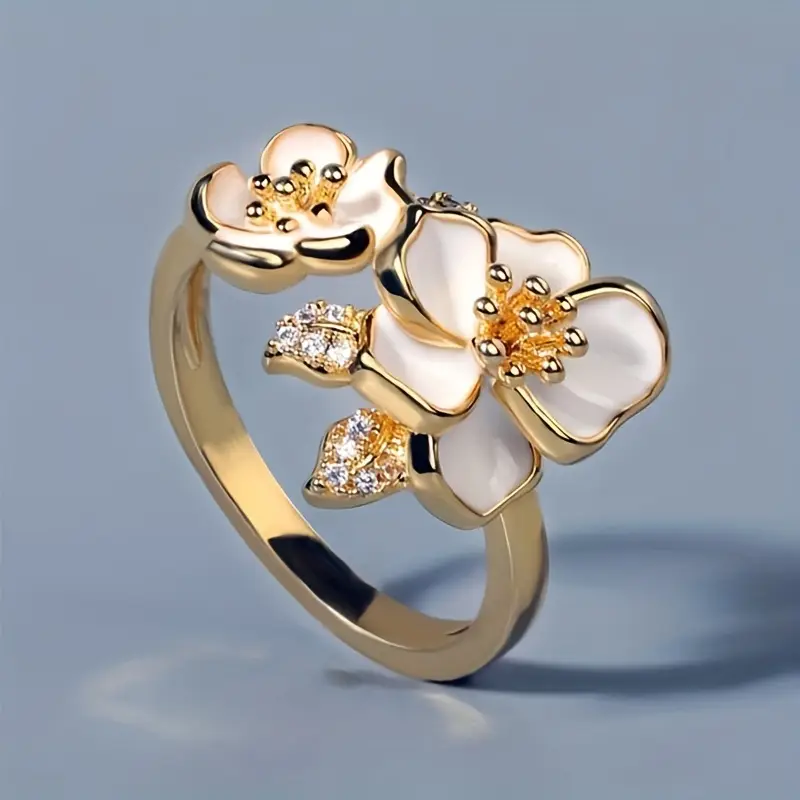Gold ring with white flowers