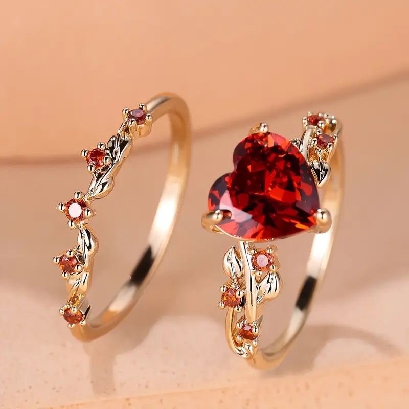 Gold ring set with red crystals and heart